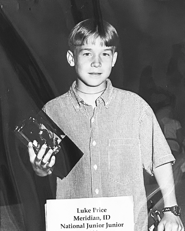 Photograph of Luke Price, National Junior Junior 1998, holding trophy.