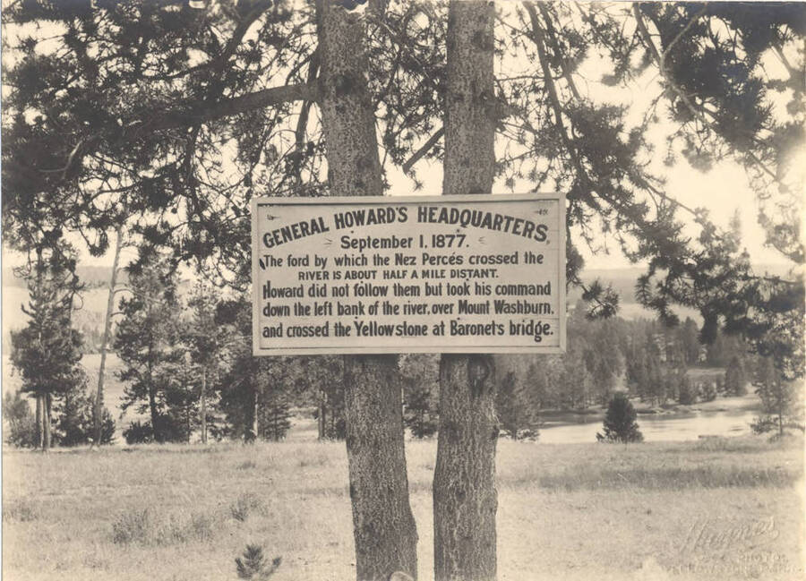 Photograph of a sign marking where General Howard's Headquarters was located on September 1, 1877. It says "The ford by which the Nez Perces crossed the riber is about half a mile distant. Howard did not follow them but took his command down the left bank of the river, over Mount Washburn, and crossed the Yellowstone at Baronets bridge."