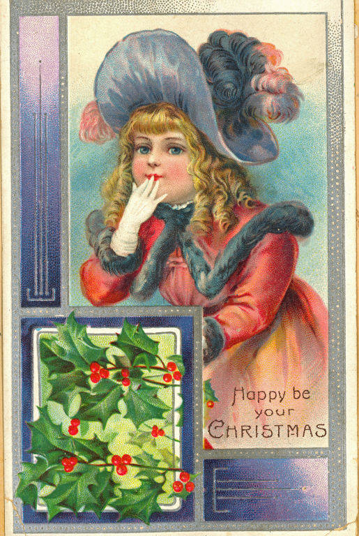 A young girl wearing a large, feathered hat and a fur-trimmed coat appears to be blowing a kiss or covering her mouth with her gloved hand. Beside her, there is an illustration of holly leaves and berries. The text reads "Happy be your Christmas."