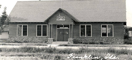 A wooden building with stone accents at the base, featuring a gabled roof. The sign above the door reads "Park Ridge Lodge 155 IHL." There are four large windows, two on each side of the central entrance. Overgrown grass surrounds the building. The text "Franklin, ILL." is written at the bottom.