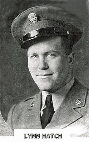A person wearing a military uniform with a hat, featuring an emblem. The individual has a slight smile. Below the image is the text: "Lynn Hatch."
