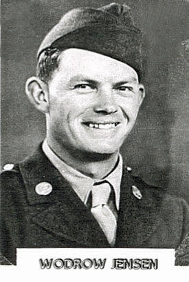A man in a military uniform is smiling. He is wearing a cap and has visible insignias on his uniform. The name "WODROW JENSEN" is written below him.