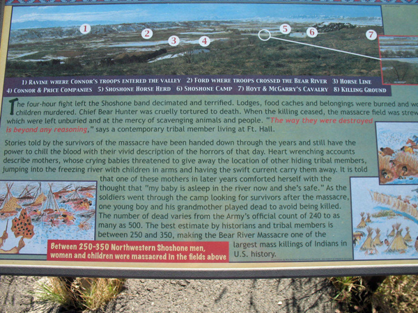 This is a historical information display about the Bear River Massacre. It includes a panoramic map with labeled points of interest such as the ravine, troop crossing point, horse line, and killing ground. Below the map is text describing the massacre, emphasizing the horror faced by the Northwestern Shoshone, with a quote noting the atrocity. Stories of survivors are recounted, depicting the lasting impact. The panel also mentions the estimated death toll, citing between 250-350 individuals. There are small illustrations of lodges and a depiction of the event.