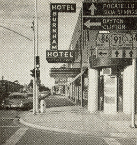 Street view featuring signs for Hotel Burnham and a cafe. Directional signs point to Pocatello, Soda Springs, Dayton, and Clifton. Traffic lights and a parked car are visible. Road signs display numbers 86, 91, and 34.