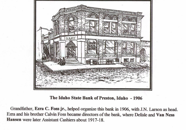 A drawing of a two-story brick building labeled "Bank" in the front. The sign reads "Idaho State Bank." There are stairs leading to double doors at the entrance. The building is situated on a street corner. Below the image, the caption reads: "The Idaho State Bank of Preston, Idaho - 1906." Additional text mentions Ezra C. Foss Jr., who helped organize the bank with J.N. Larson. Ezra and his brother Calvin Foss became directors of the bank, with Delisle and Van Ness Hansen as assistant cashiers around 1917-18.