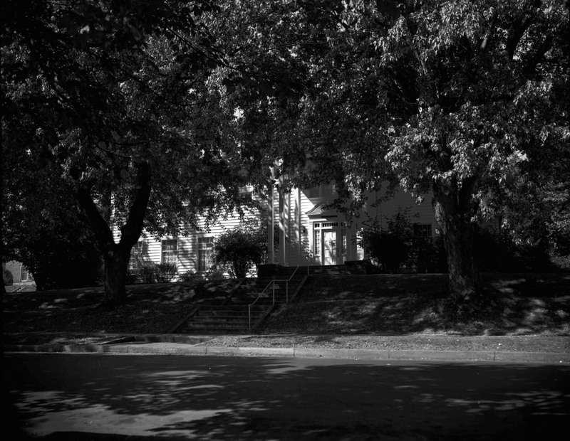 A photograph of Kappa Kappa Gamma sorority house with two large trees in front of it.