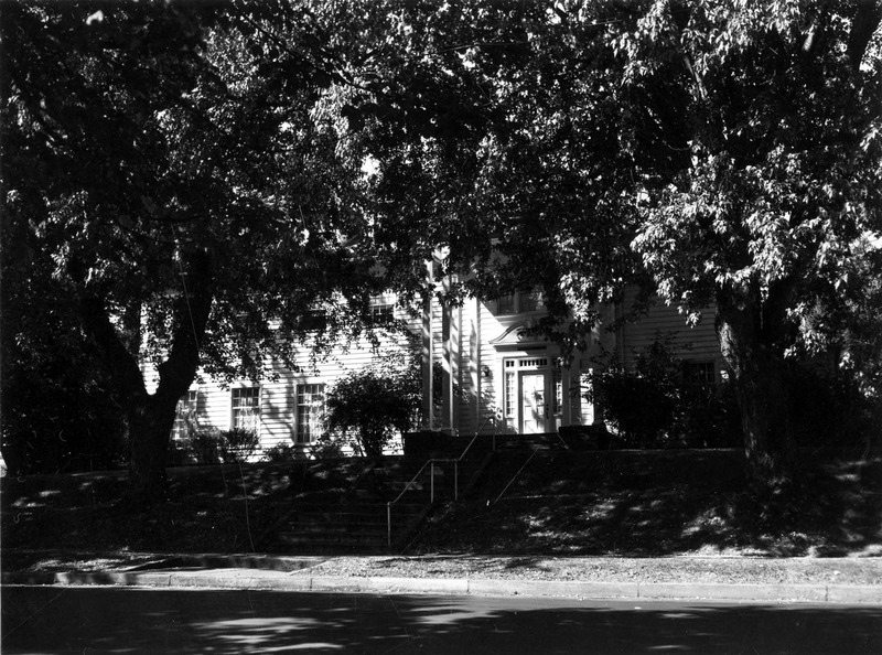 A photograph of Kappa Kappa Gamma sorority house with two large trees in front of it.