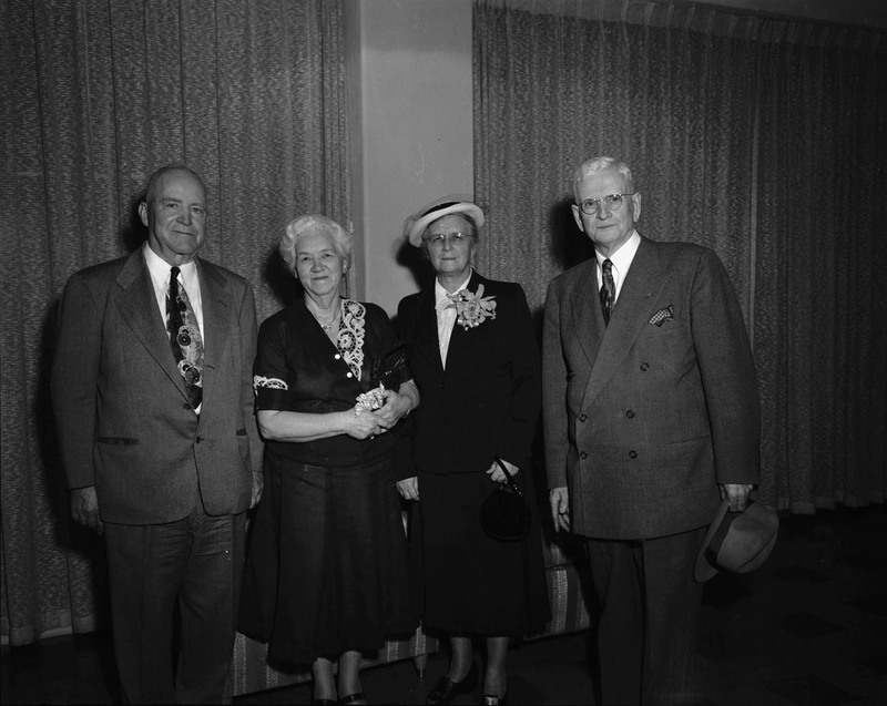 Group portrait of two men and two women posing together at the class of 1927 reunion.