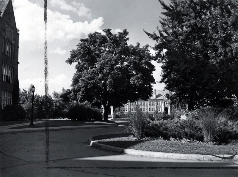 A photograph taken in front of the Administration Building, Life Sciences South Building can be seen in the background.