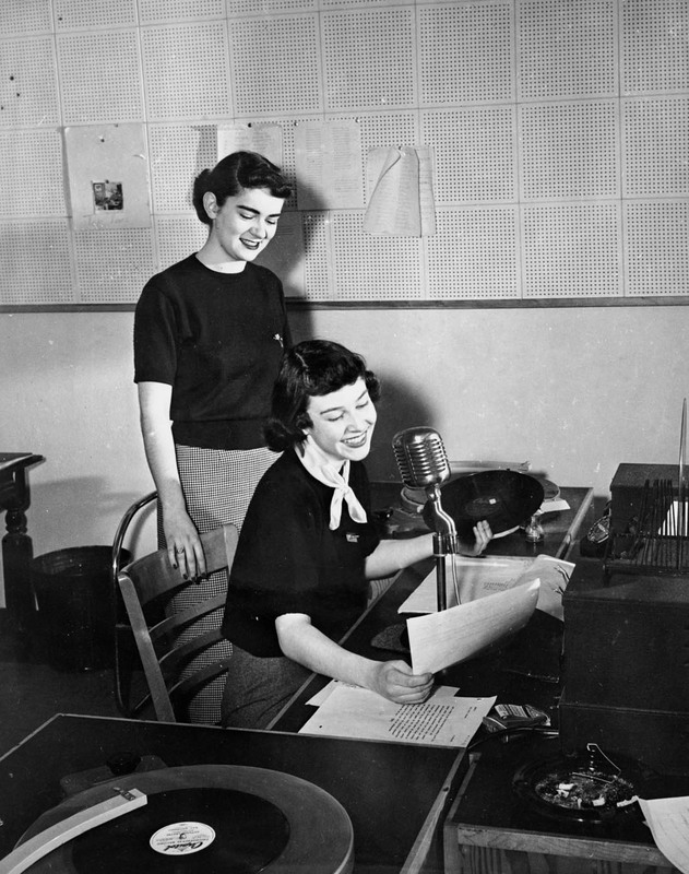 Two female students announcing on the KOUI radio station, a student-run broadcast.