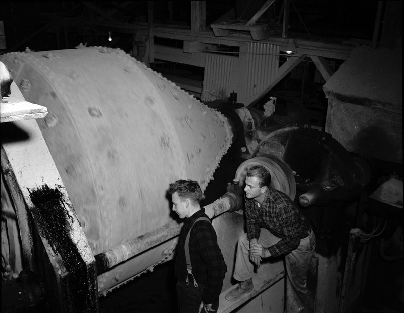 Students examining a rock tumbler on their geology field trip.