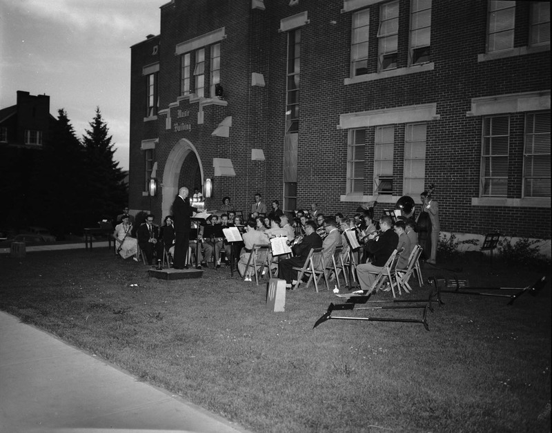 Students being led by conductor Carl Claus during outdoor orchestra practice outside of the Music Building.