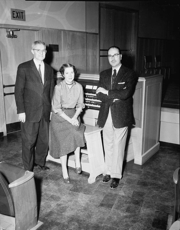 Music Department faculty Hall McInTyer Macklin at his piano with colleagues Marian Frykman, instructor, and an unidentified man.