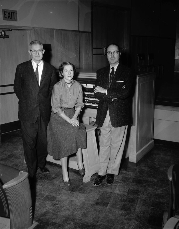 Music Department faculty Hall McInTyre Macklin at his organ with colleagues Marian Frykman, instructor, and an unidentified man.