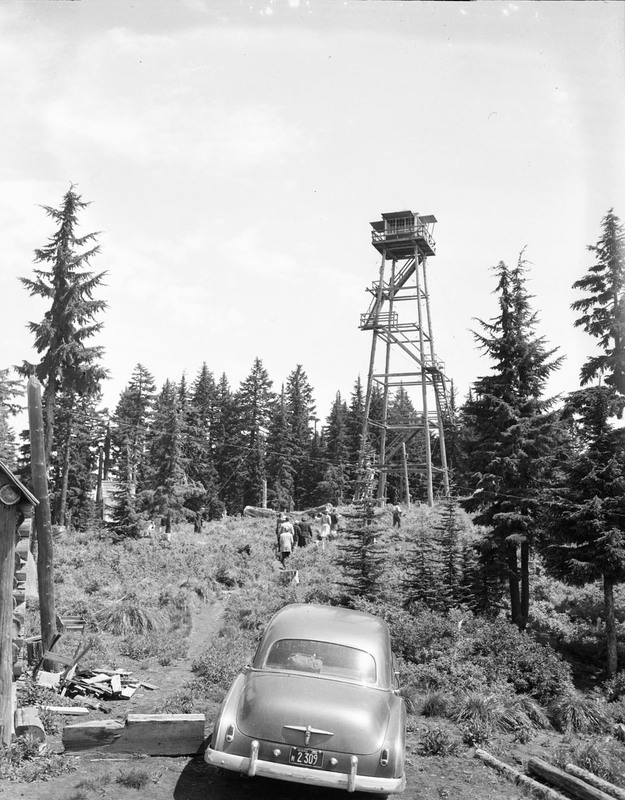 Summer hiking class held in a scenic wooded area. An automobile can be seen in the foreground.
