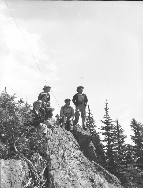Students in a summer hiking class at the top of a boulder.