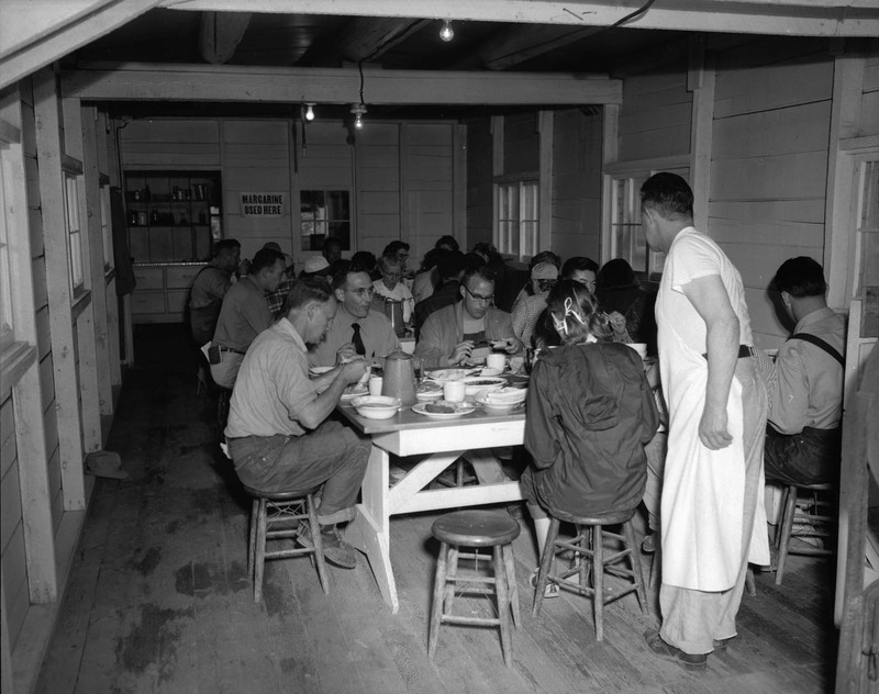 Students eating together in a mess hall.