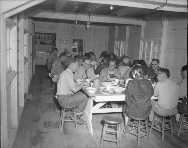 Students eating together in a mess hall.