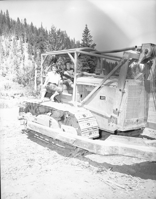 Students pose in a bulldozer.