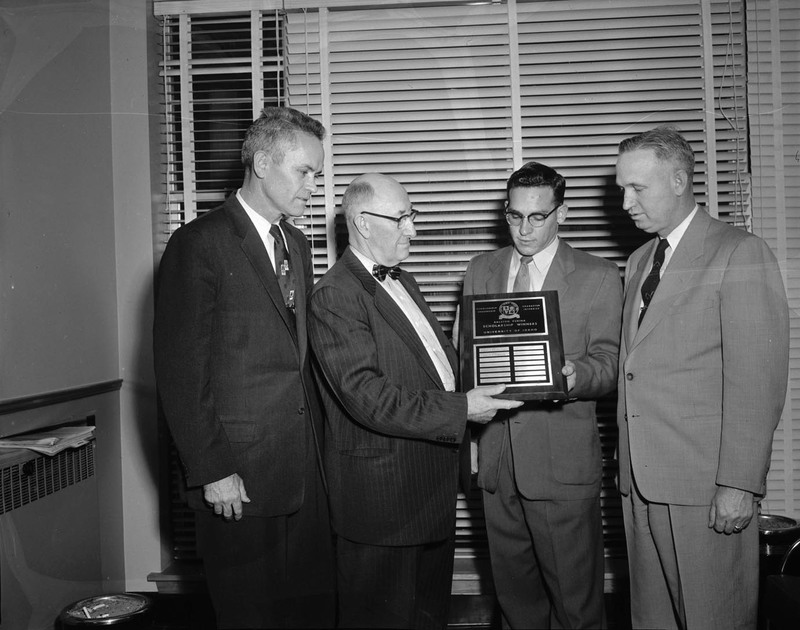 Left to right: Dean Don Marshall, D.L. Fourt, Phillip Edwards, and Dean Kraus receiving the Ralston Purina Company Award.