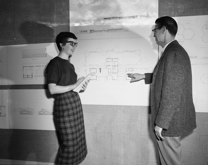 Molly Godbold and Architecture Department Head Charles Bartal looking at architectural drawings.