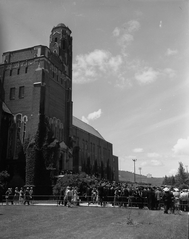 Students gather outside the Memorial Gym for Commencement.