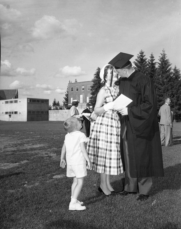 Graduate John J. Miller posing with his family at commencement.