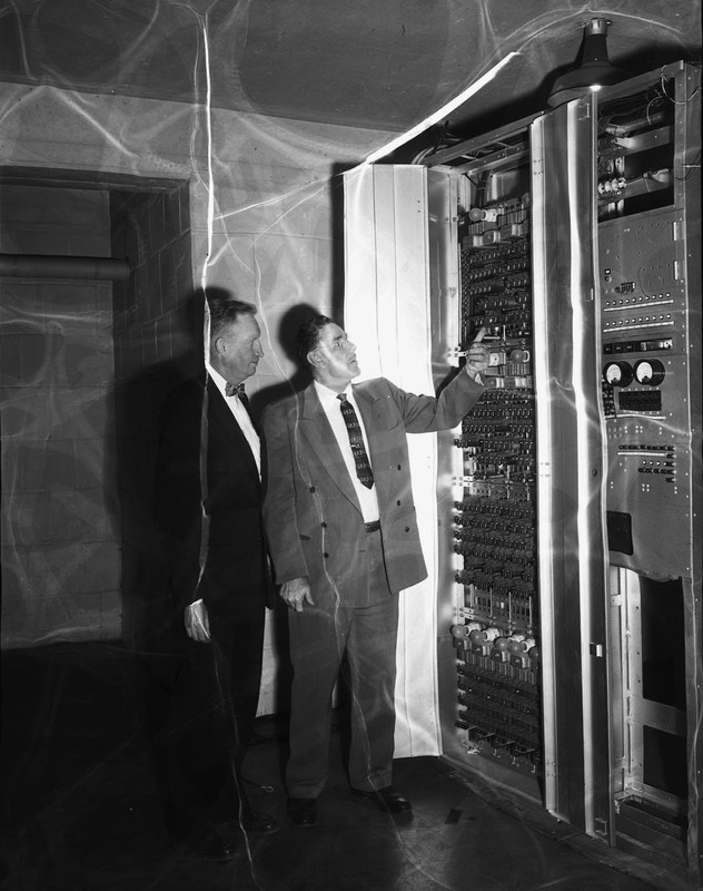 College of Engineering H.E. Hattrup (left) and W.S. Taylor district supervisor for General Telephone giving the university a relay switch board.