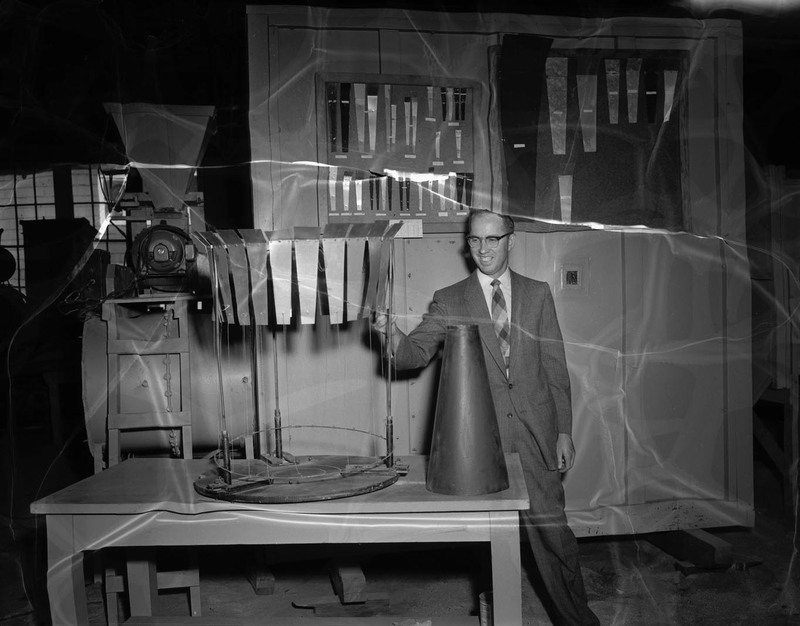 C.C. Warnick, College of Engineering faculty, standing with equipment.