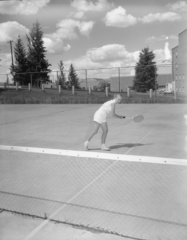 Tennis team member Sissel Andreason gets her portrait taken on the tennis court.
