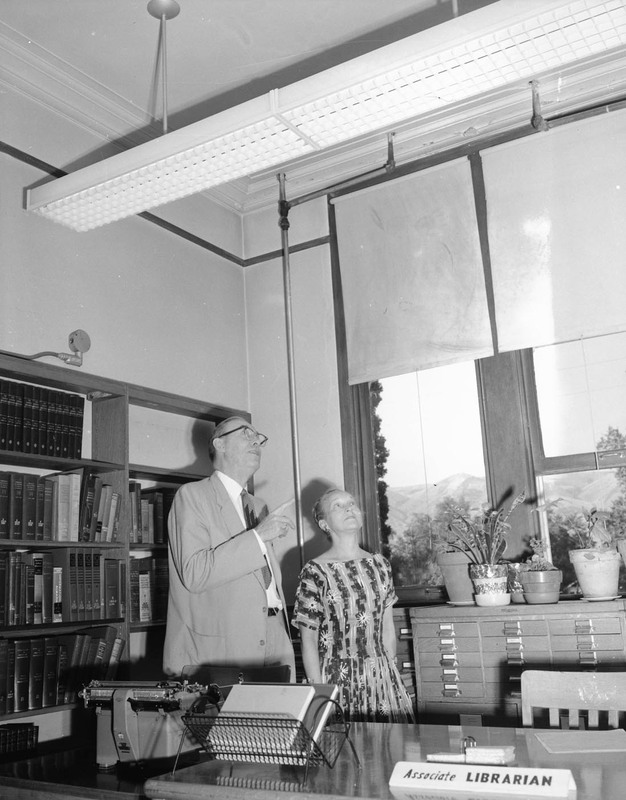 Dean Cleon C. Caldwell inspecting new lights with associate librarian at Lewis-Clark State College.