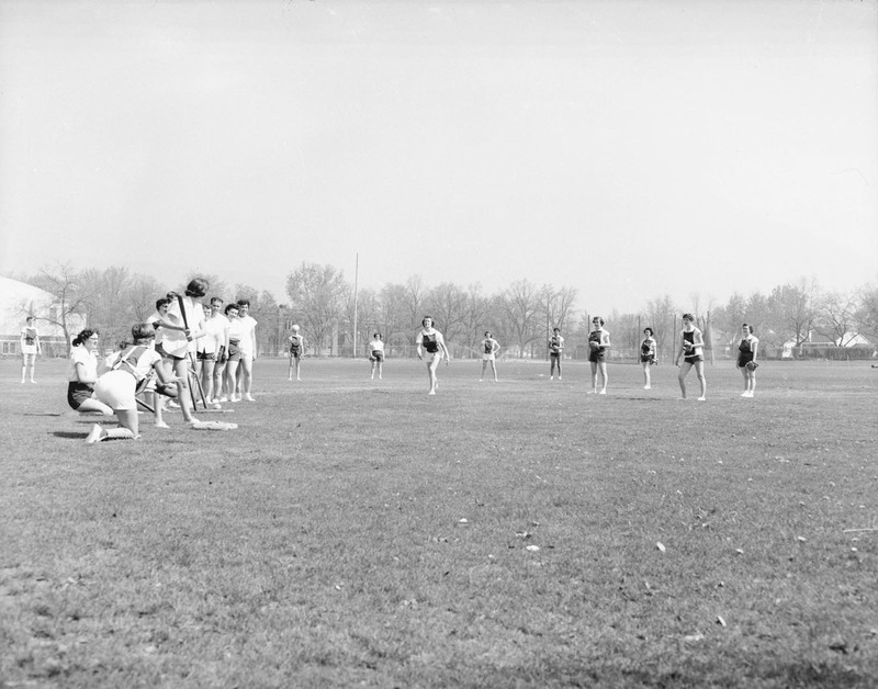 Women in a field playing softball at Lewis-Clark State College.