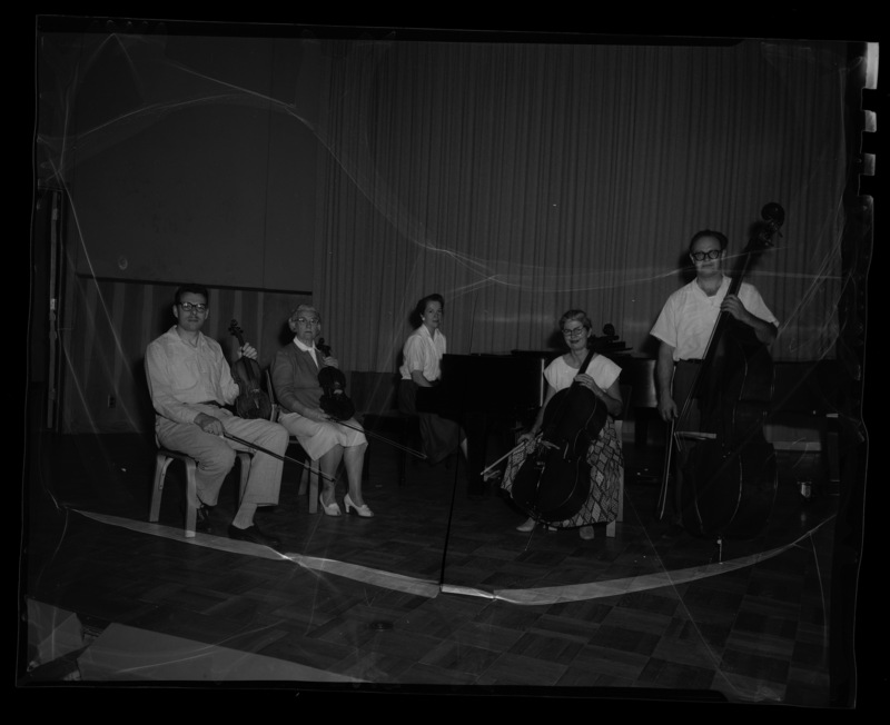 A muscial quintet practicing their instruments (l-r) LeRoy Bauer, unidentified, Marian Frykman, unidentified, and David Whisner.