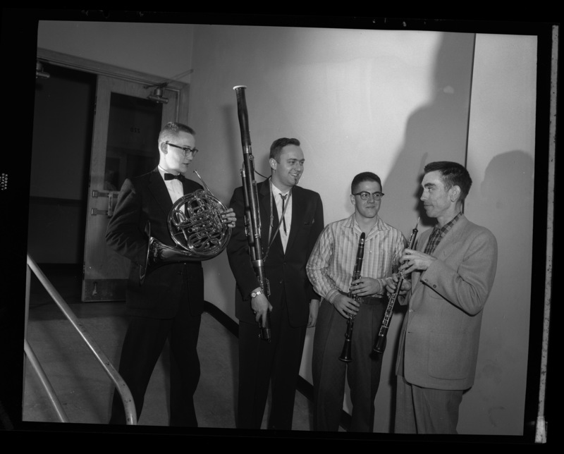 Warren Bellis (front), University of Idaho director of band, stands in line with several soloists for a concert.