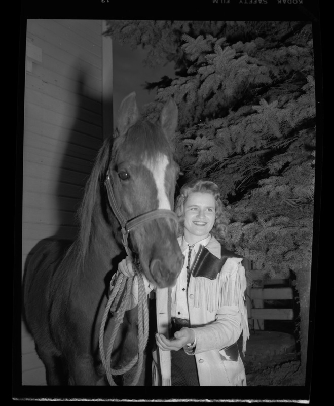 College of Agriculture student Sonja Carlson, second female graduate in animal husbandry, showing a horse.