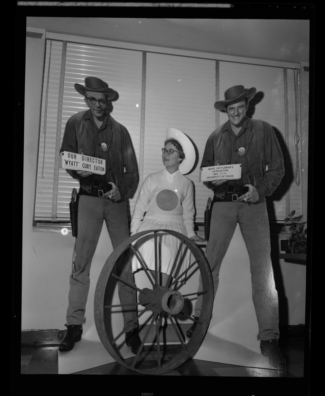 President of the Spurs, Blanche Blecha, poses with carboard cut outs of ICA director "Wyatt" Curt Eaton and Gunsmoke star, James Arness.