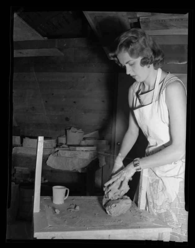 Mrs. James Douglass working with clay in Art and Architecture inside the Pottery Lab (later the Drama Annex) at University of Idaho.