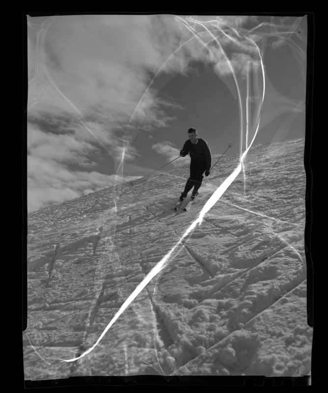 University of Idaho ski team member Chuck Rank skiis down a snowy slope.