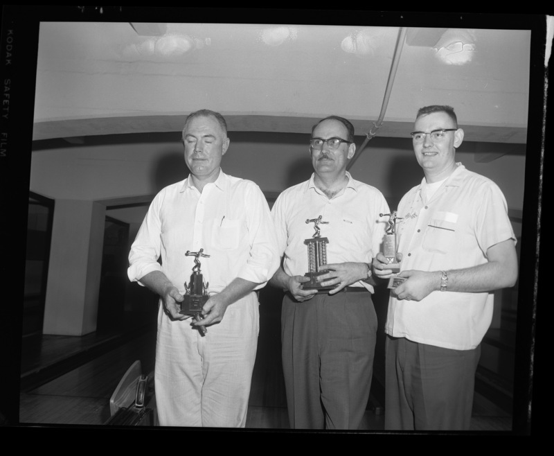 A University of Idaho faculty bowling team poses with their trophies in the SUB bowling alley.