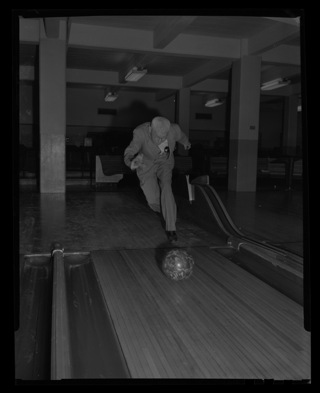 A man bowls in the Student Union Building bowling alley.
