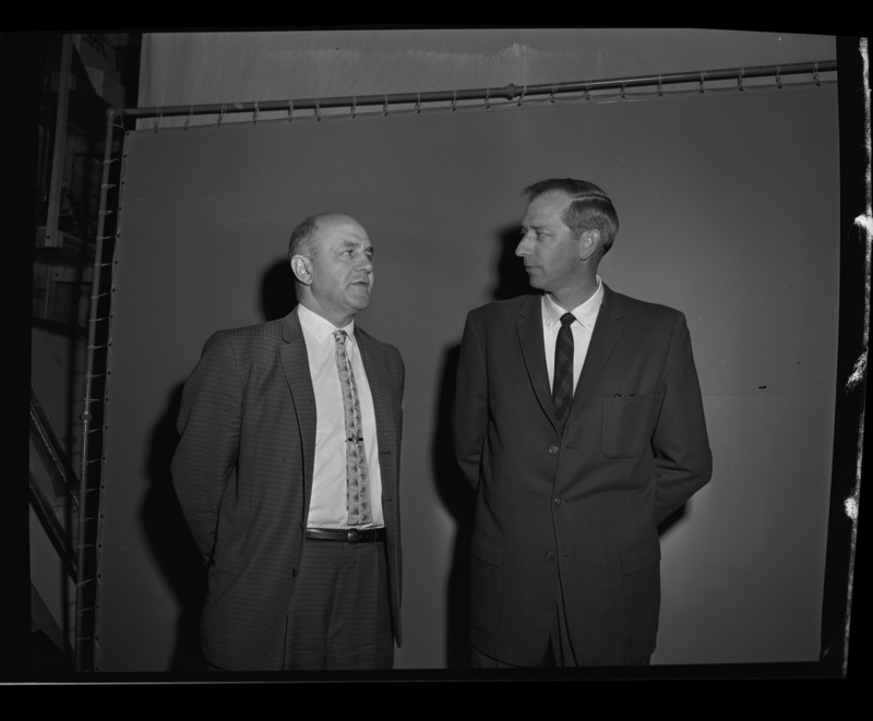 Two unidentified men talking while applying as prospective basketball coaches.