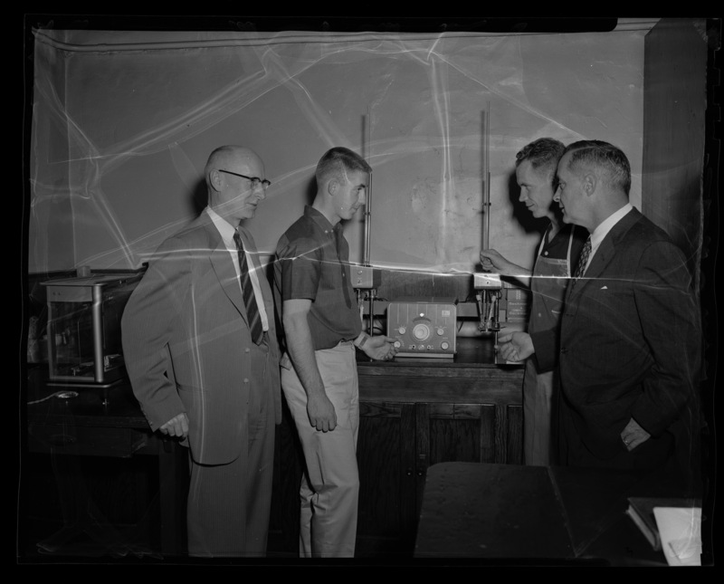 Head of Pacific Division of Dupont Manufacuring meeting with Dr. J. Hugo Johnson, Chair of the Electrical Engineering department, and two unidentified University of Idaho students.
