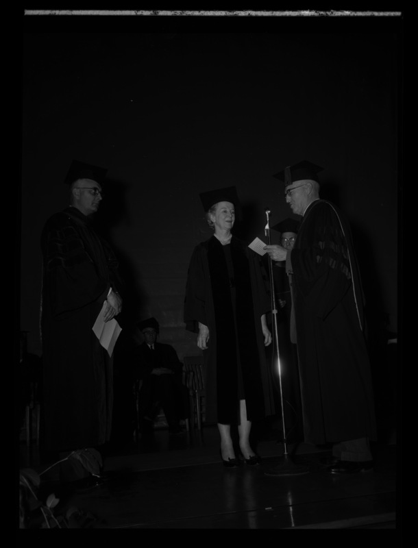 Newspaper columnist Inez Callaway Robb recieving an honorary degree in literature from President Theophilus on stage at commencement. Dr. Boyd A. Martin, Dean of Letters and Science, on the left.