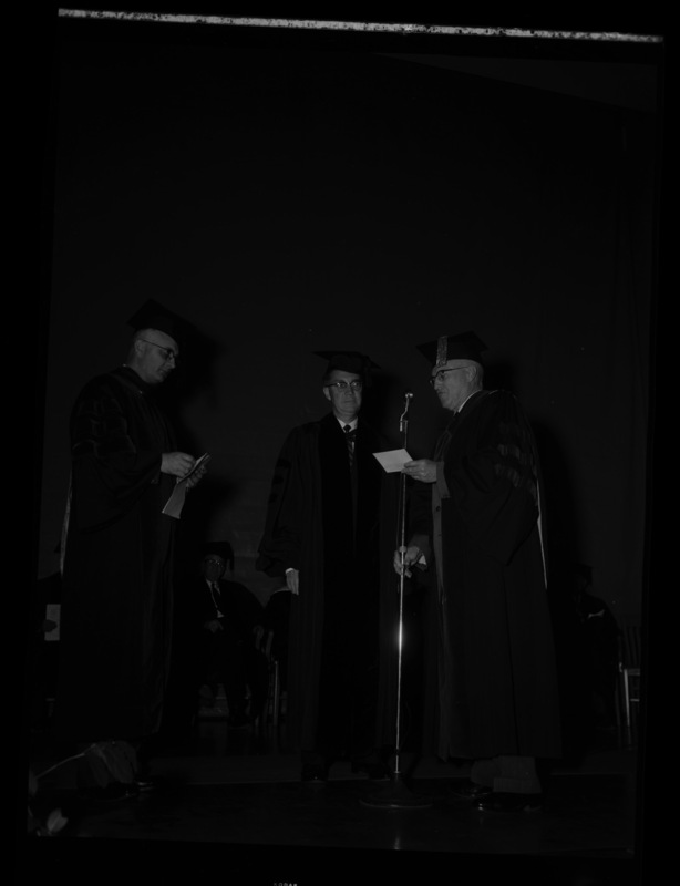 Dr. Lawrence Chamberlain receives an honorary Doctor of Laws degree from University of Idaho President Donald Theophilus at the commencement ceremony. Dr. Boyd A. Martin, Dean of Letters and Science, on left.