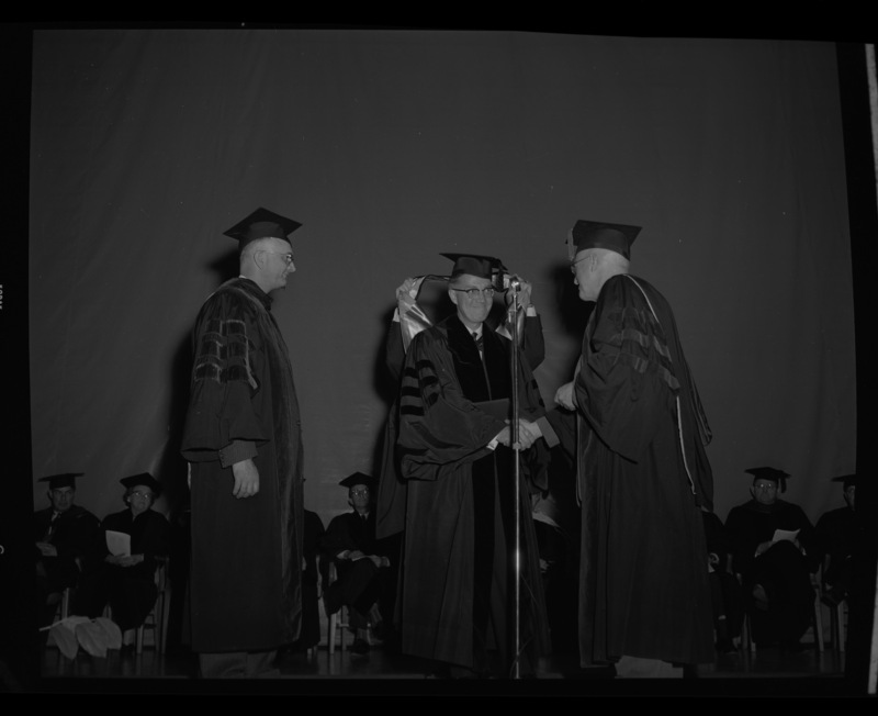 Dr. Lawrence Chamberlain receives an honorary Doctor of Laws degree from University of Idaho President Donald Theophilus at the commencement ceremony. Dr. Boyd A. Martin, Dean of Letters and Science, on left.