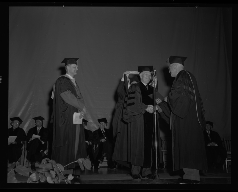 Carl G. Paulsen (center) is hooded and receives an honorary Doctorate of Science degree on stage with Dean of Engineering, Alan Janssen (left), and President Theophilus (right) at commencment.