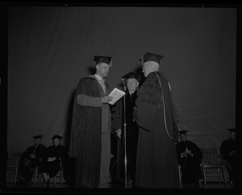 Carl G. Paulsen (center) receives an honorary Doctorate of Science degree on stage with Dean of Engineering, Alan Janssen (left), and President Theophilus (right) at commencment.