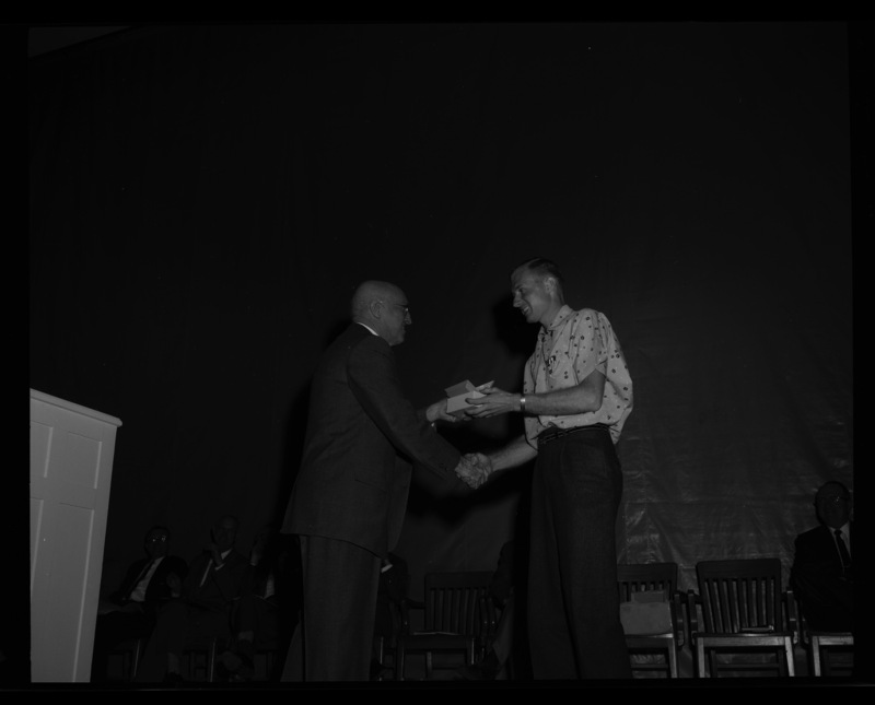 President Theophilus gives the North Idaho Forestry Association Award to Donald L. Hauxwell at the 1960 May Fete.