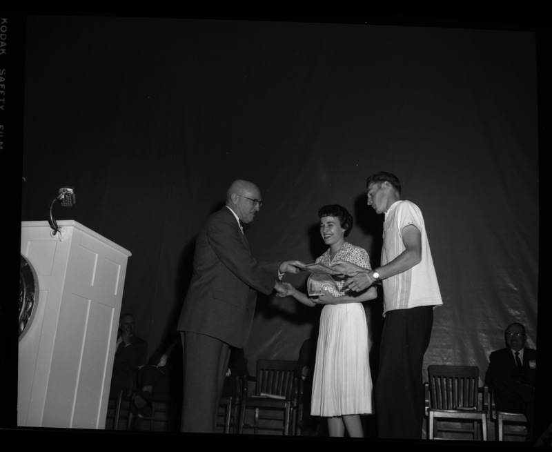 President Theophilus gives the Idaho Congress of Parents and Teachers Award to Nancy Wilmuth and Earl Owen at the 1960 May Fete.