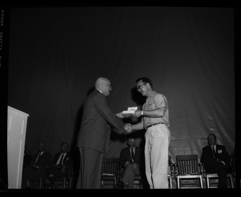 President Theophilus gives the Hamilton Watch Award to Leo D. Tafolla at the 1960 May Fete.